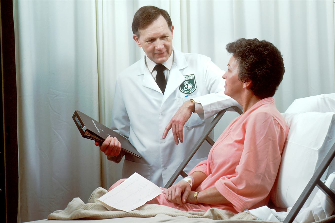 Dentist talking with a patient in the treatment chair